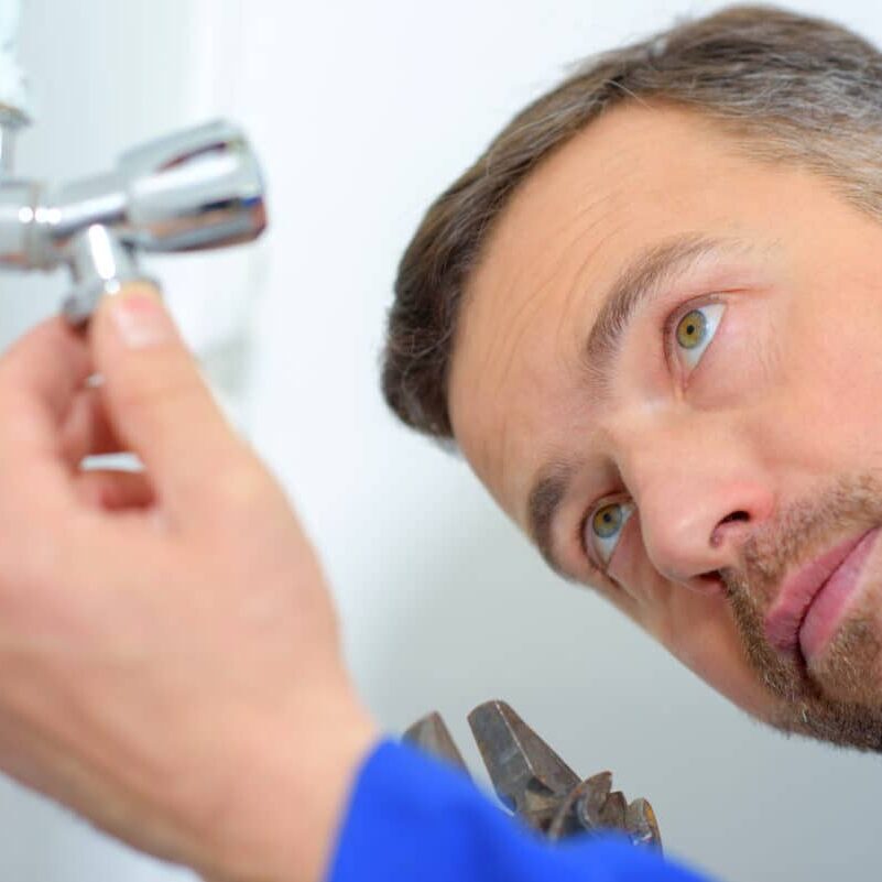 repair man fixing shower and sink water damage leaks